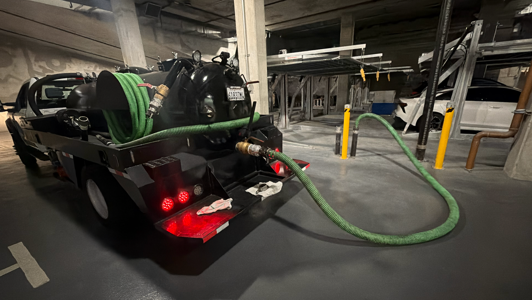 Vacuum service truck pumping cooking oil from an underground collection point for cooking oil disposal in Fowler, California