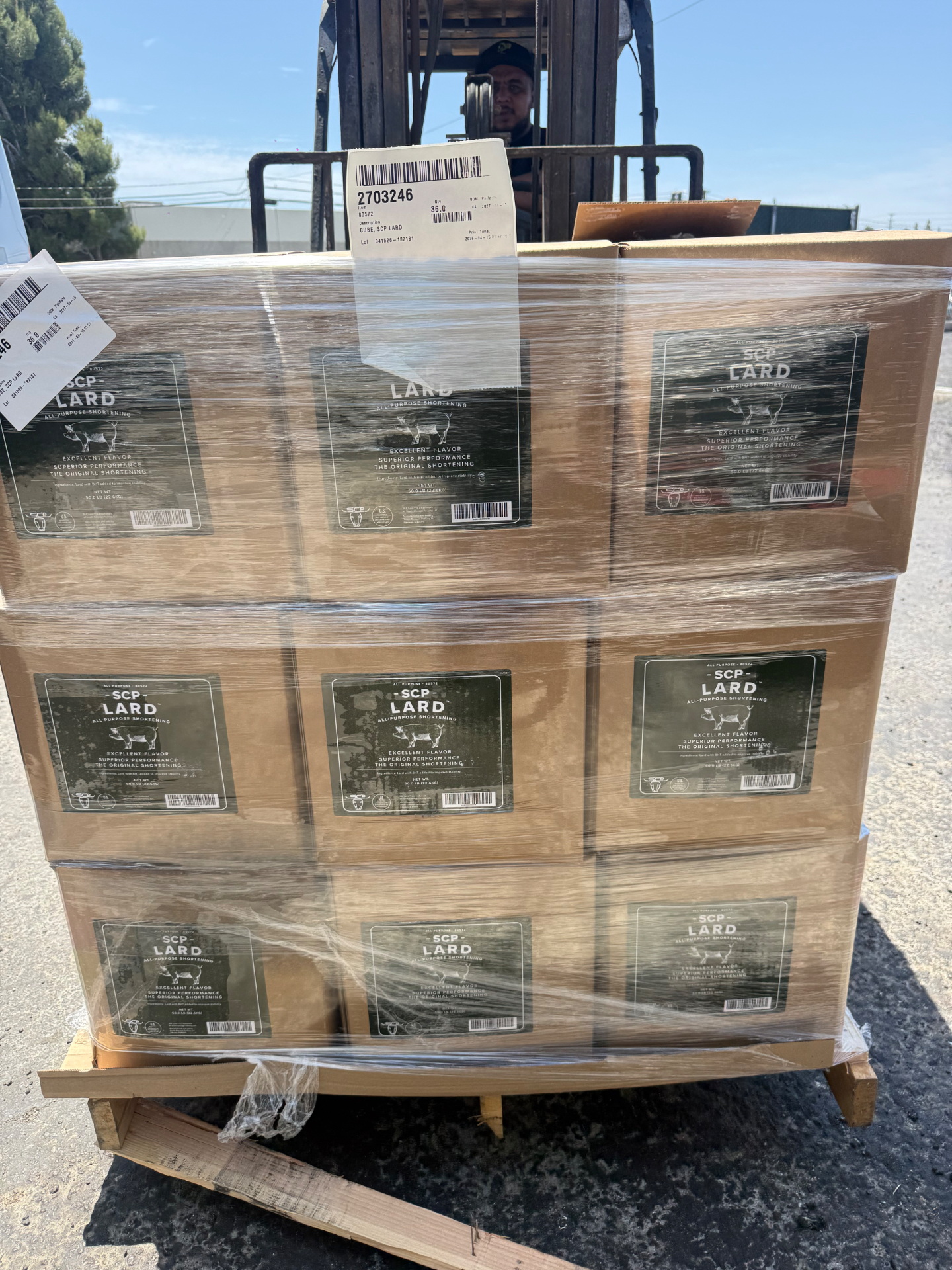 Palletized expired lard and shortening inventory evaluated for removal Shrink-wrapped pallet of expired lard and shortening boxes awaiting bulk oil disposal evaluation